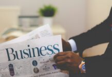 man in suit holding business newspaper for Cvent acquires Reposite announcement