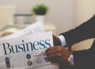 man in suit holding business newspaper for Cvent acquires Reposite announcement