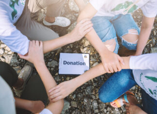 How to Help Event Professionals Affected by LA Fires Close up of people volunteer teamwork join hands