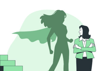 Business woman with shadow of super woman in cape