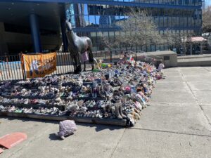 the shoe memorial, a tribute to the lives lost to Canada's residential school system on the steps in front of Calgary's municipal plaza.
