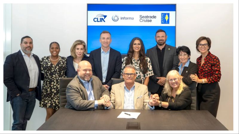 Bud Darr, Andrew Williams and Michele Paige shake hands on the new deal watched by colleagues from CLIA, FCCA and Seatrade Cruise. Photo courtesy of FCCA.