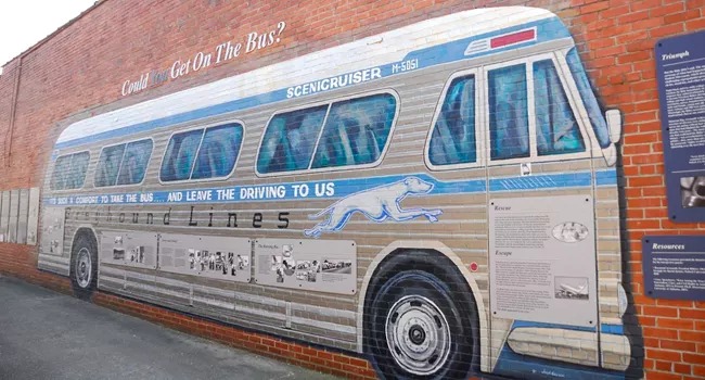 A mural of a bus is painted on a brick wall at Freedom Riders National Monument, AL.
