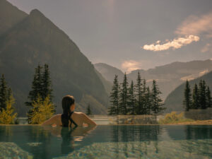 Woman enjoying the view at the Chateau's BASIN Glacial Waters outdoor vitality pool. 