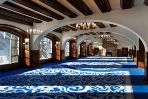 The Fairmont Chateau Lake Louise's Victoria Ballroom is a restored 1913 space with vaulted ceilings, crystal chandeliers, a stone fireplace and lakefront views.