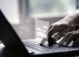 AI and Contracts: 8 Things Planners Need to Know Now Hand using laptop computer with virtual screen and document
