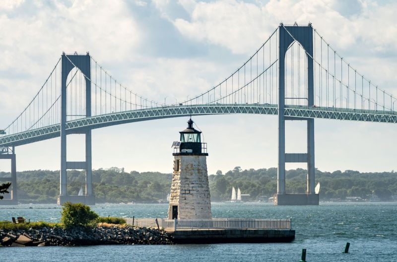 Goat Island Light and the Claiborne Pell Newport Bridge in Newport, RI, where planners will find off-season deals.